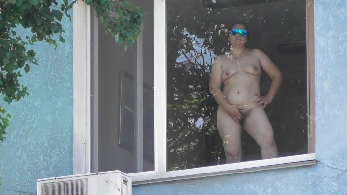 Mature wow an exhibitionist in the Window